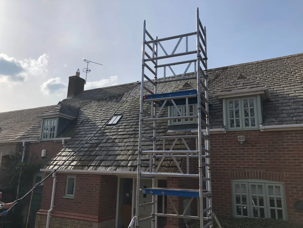 Professional roof cleaning company in Leicester removing moss and dirt from tiled residential roof using safe cleaning methods